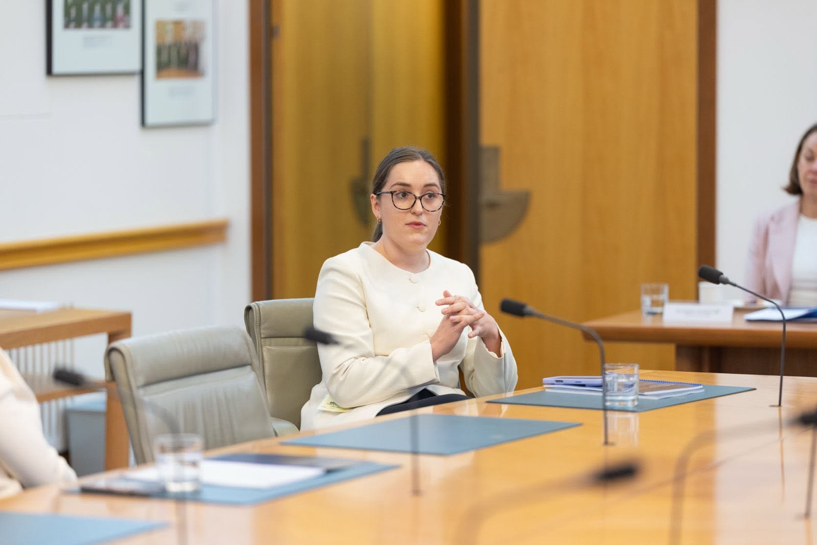 Emi Hall at a parliamentary committee table